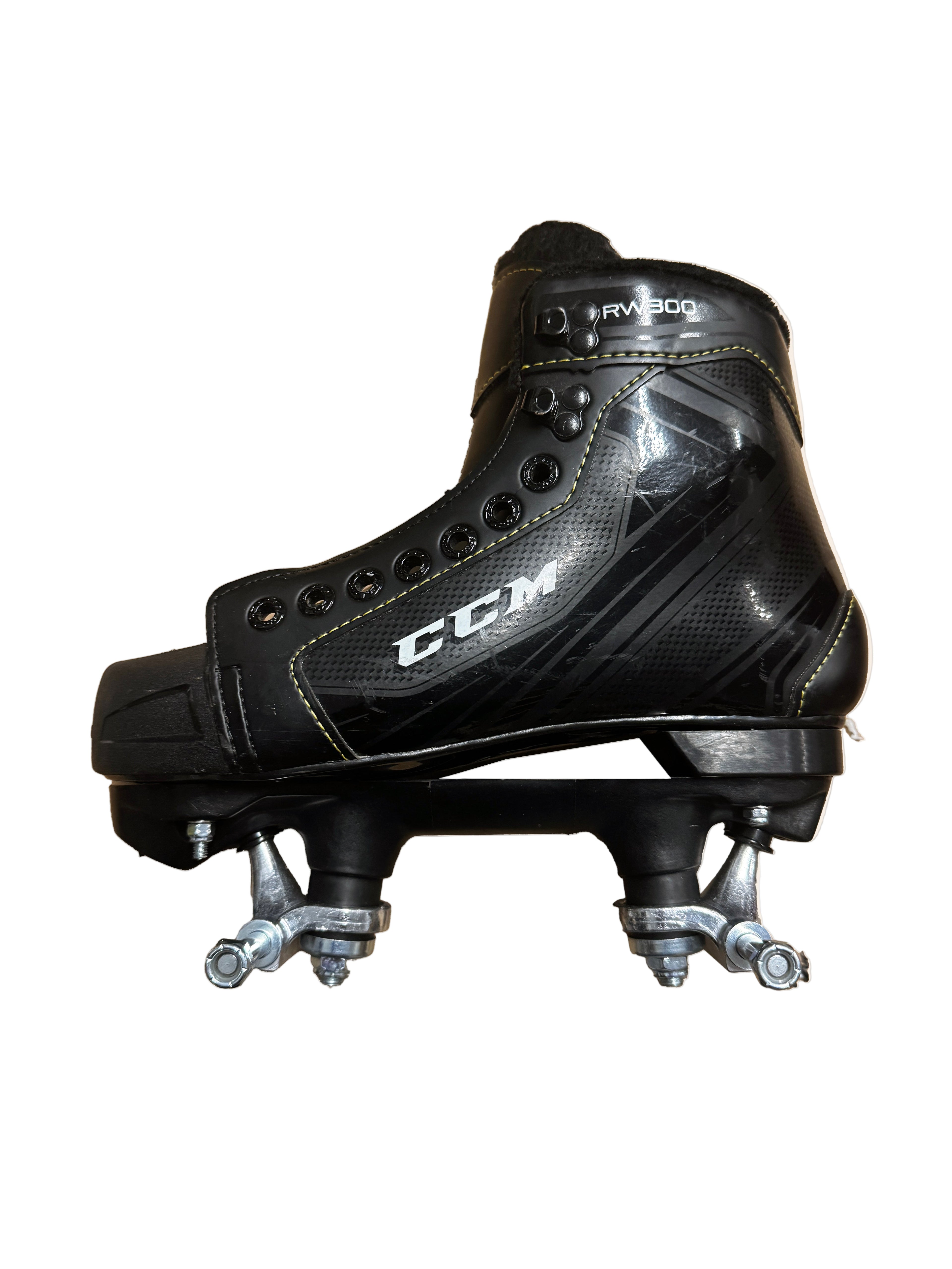 Black hockey skate with visible branding on a beige background